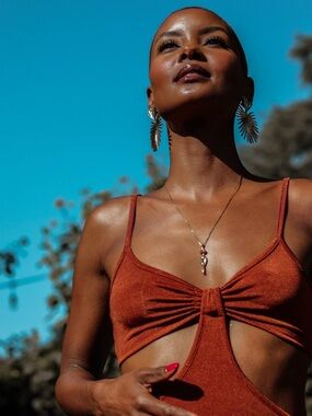 Just Polly velvet side cutout bodysuit in rust.